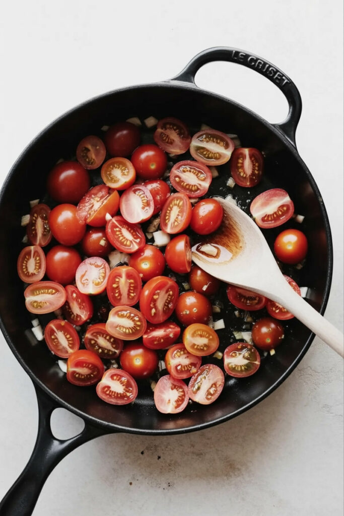 Add the garlic and tomatoes